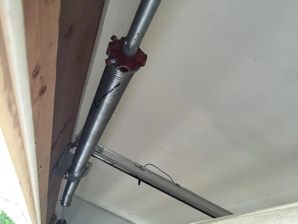 New torsion spring installed above a garage door