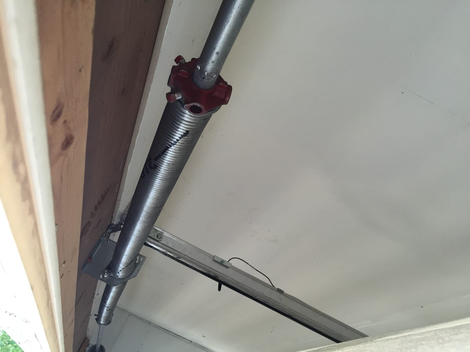 New torsion spring installed above a garage door