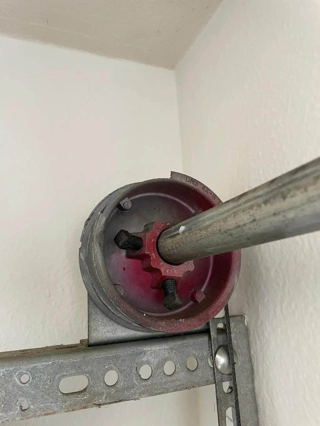 Garage door cable drum and torsion shaft assembly