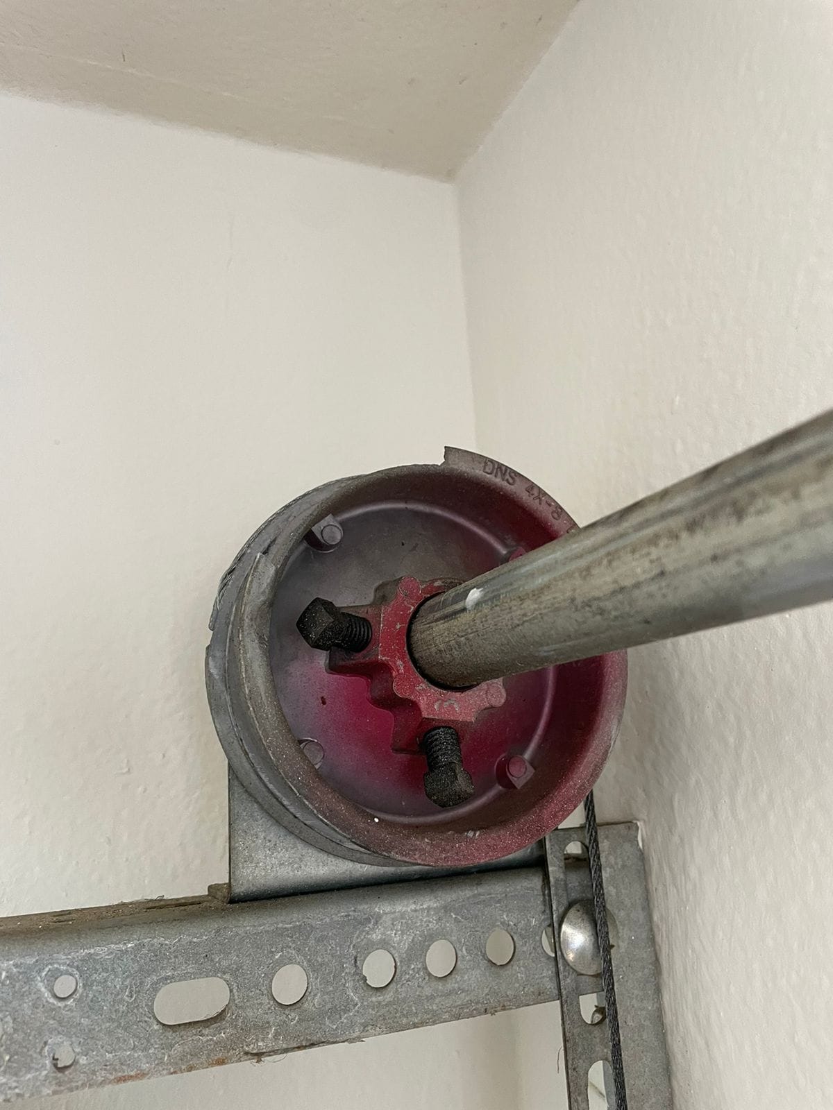 Garage door cable drum and torsion shaft assembly