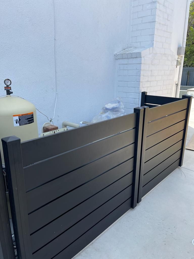 Black horizontal fence screening pool equipment
