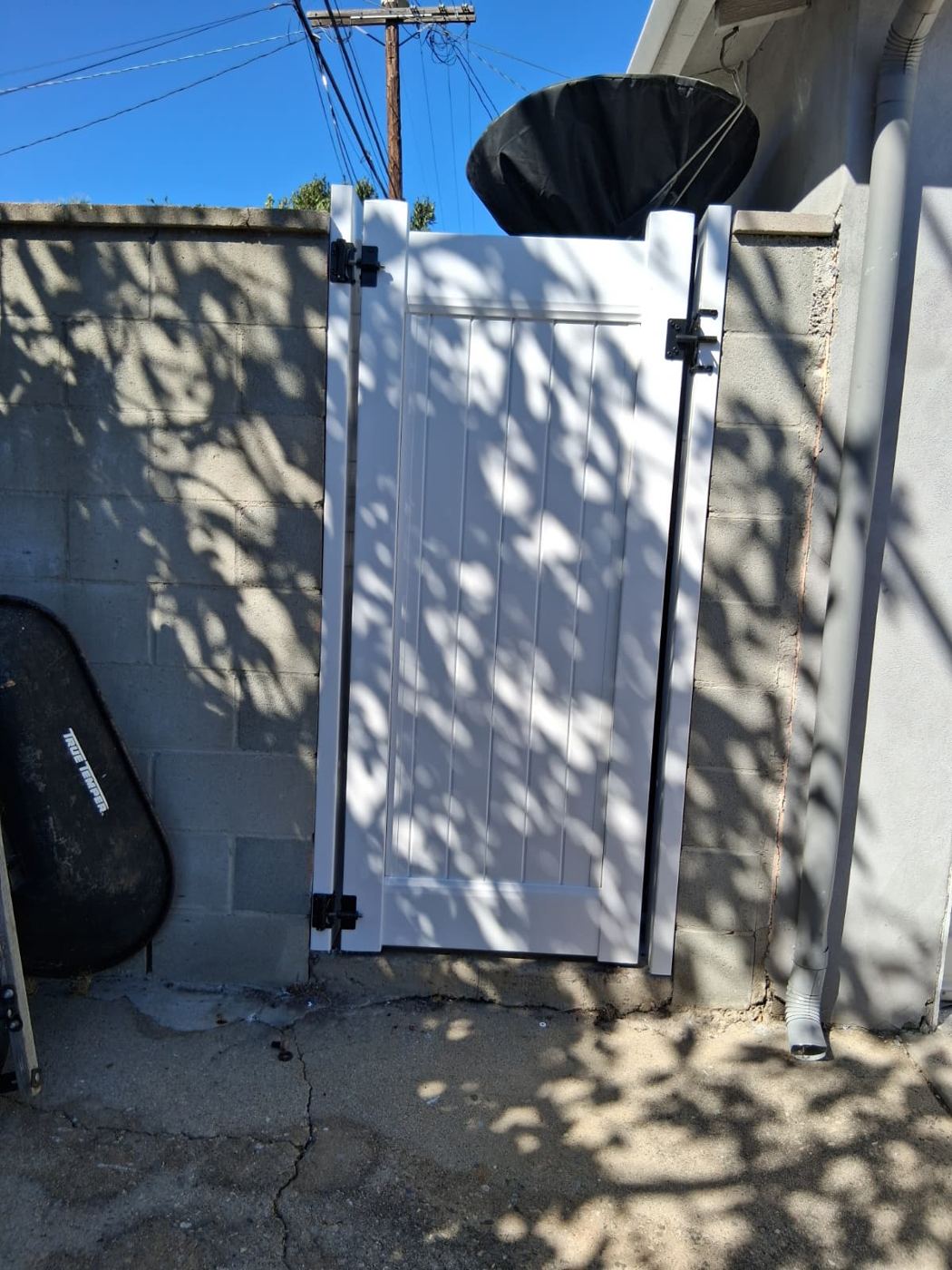 White vinyl walk gate installed between block walls