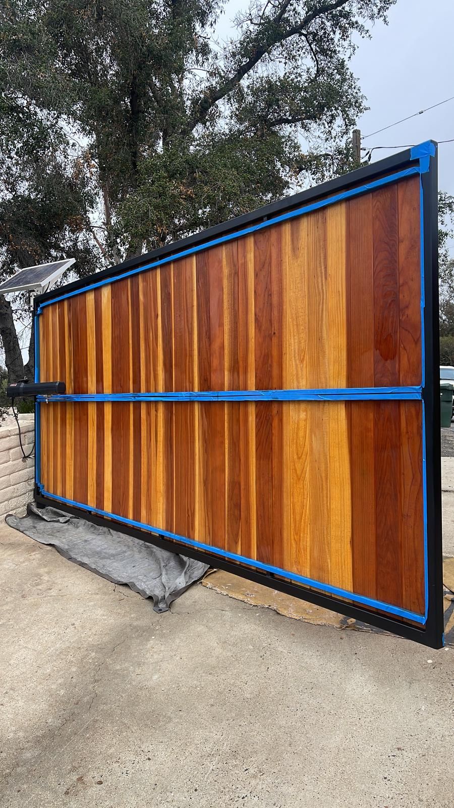 Redwood gate being sealed and stained